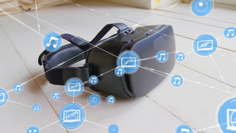 Animation of network of connections with icons over vr headset on floor