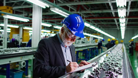 factory inspector conducting quality control on production line