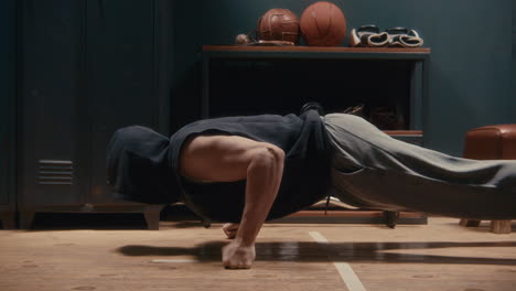 man doing push-ups in a locker room