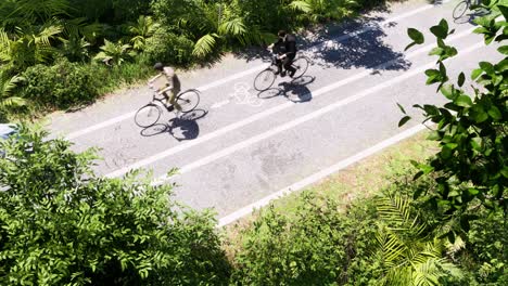 Bicycles-with-bicyclists-moving-on-a-bicycle-road