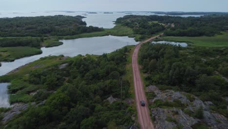 aerial view of a car driving on a scenic coastal road