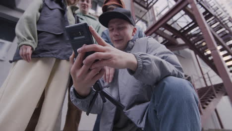 friends using smartphone on the street