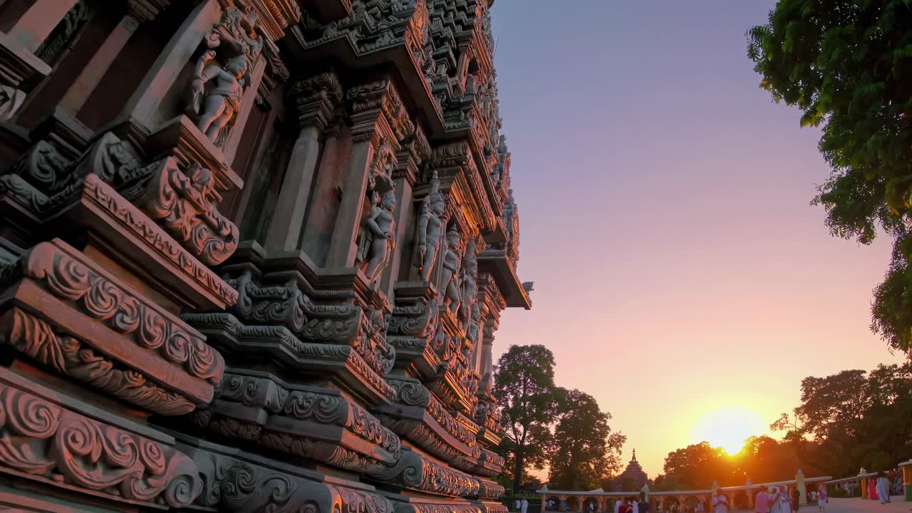 Wide-angle video captures a temple's intricate carvings at sunset, highlighting architectural