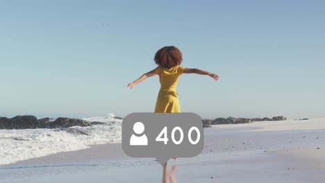 animation of speech bubble with people icon and numbers over woman spinning on beach