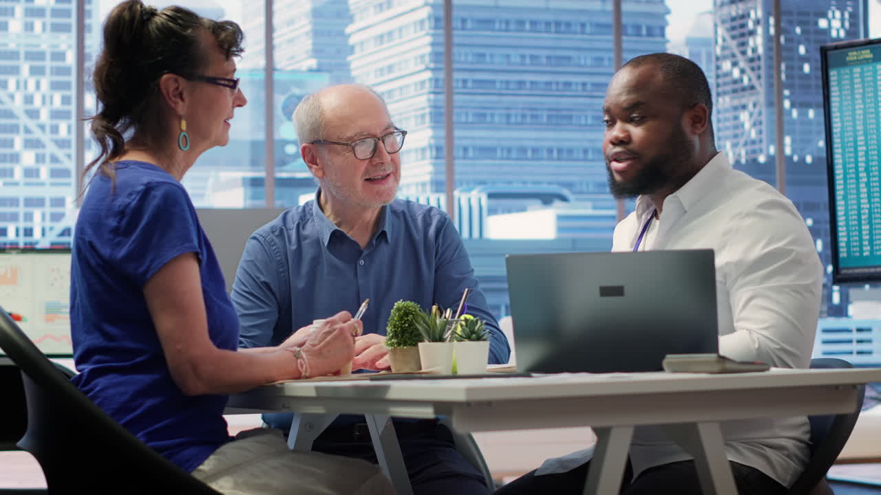 Mature couple engaged in a serious discussion with a financial banker