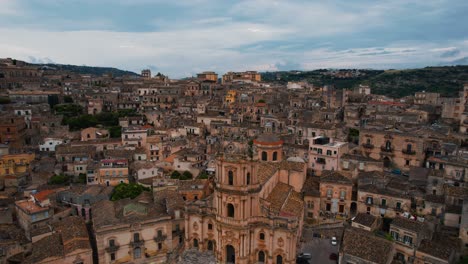 aerial of san giorgio cathedral, showing the hills around old town modica near ragusa, sicily, italy