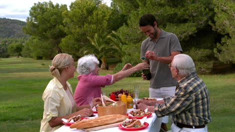 Family-opening-a-bottle-of-champagne