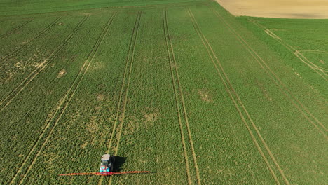 Aerial-View-Of-Tractor-Sprayer-On-Field