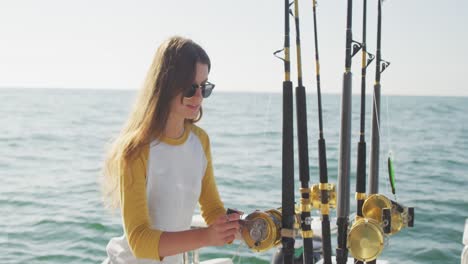 Side-view-of-a-teenage-Caucasian-girl-holding-a-fishing-rod-on-boat