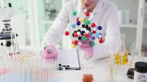Scientist working with a molecular model in a laboratory