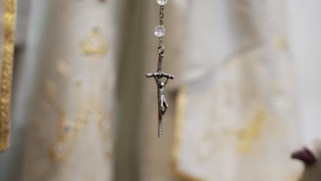 Crucifix-belonging-to-a-rosary,-close-up-in-church