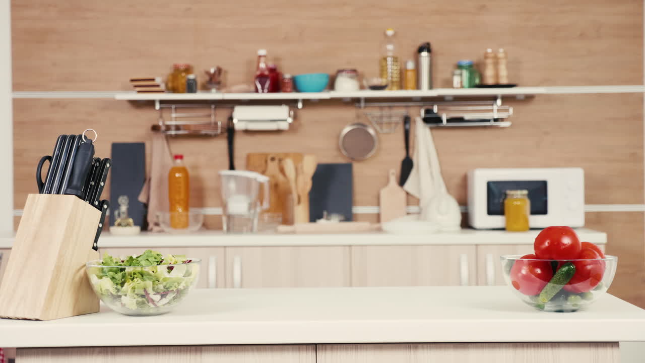 Kitchen scene with salad, tomatoes, and kitchenware