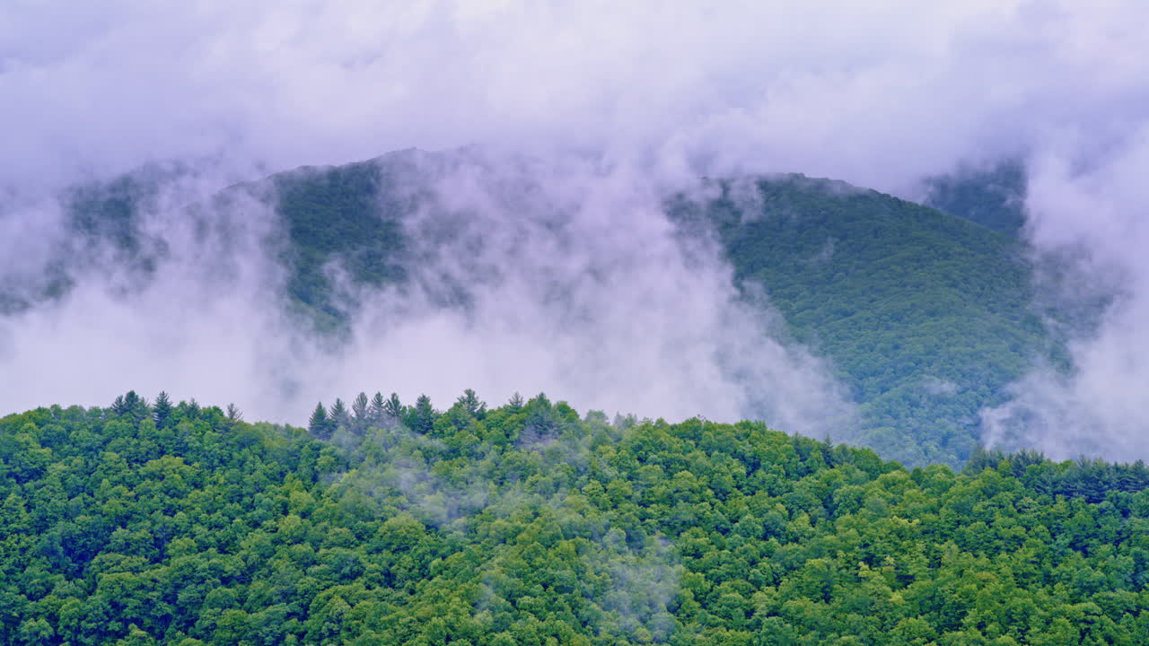 Cinematic clouds hang low over the misty Smoky range