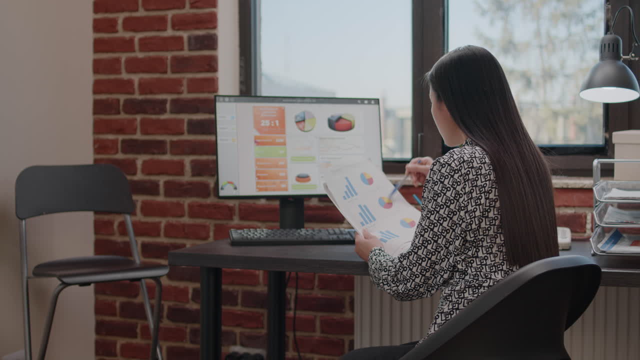 Close up of person analyzing data charts on files