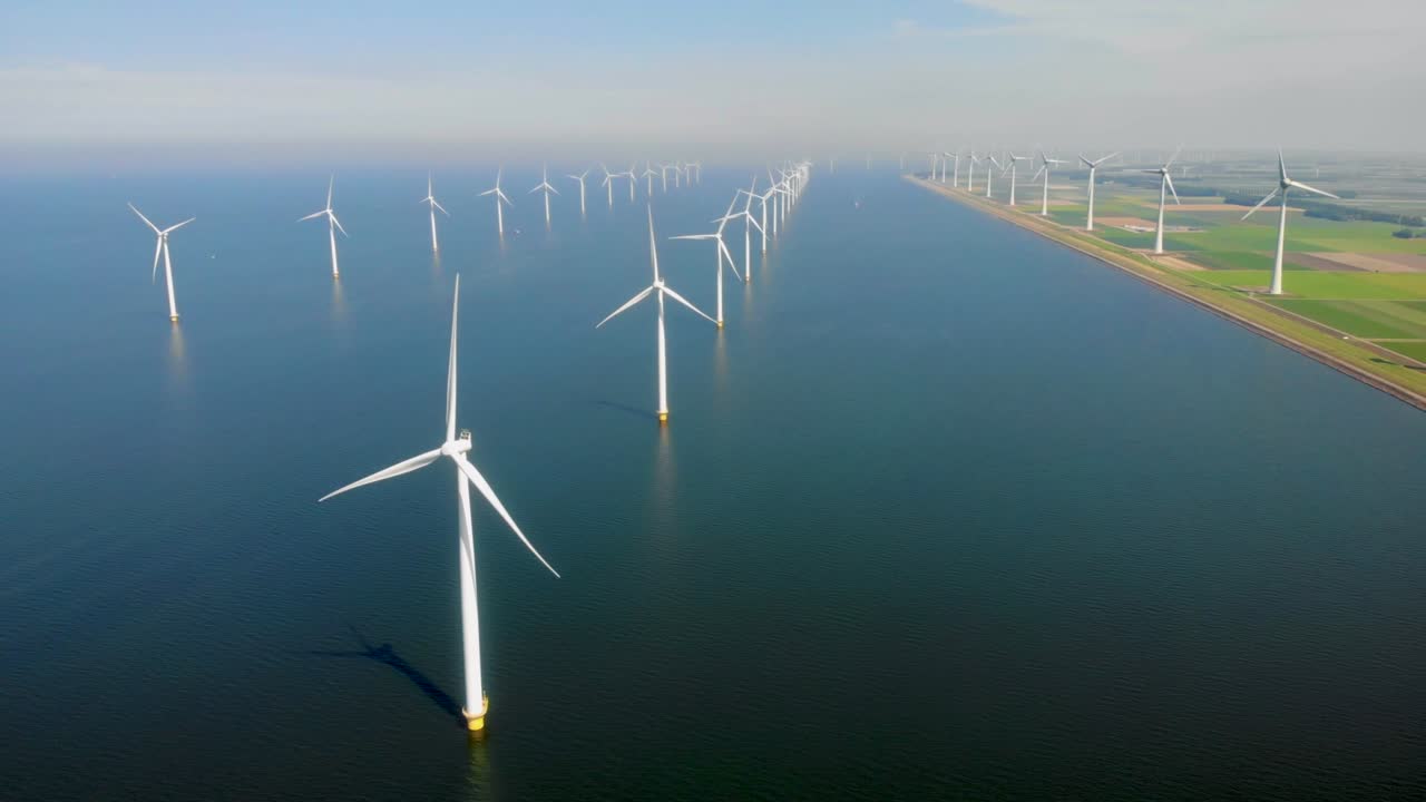 Windmill turbines, Offshore Windmill farm in the ocean Westermeerwind park , windmills isolated at sea on a beautiful bright day Netherlands Flevoland Noordoostpolder