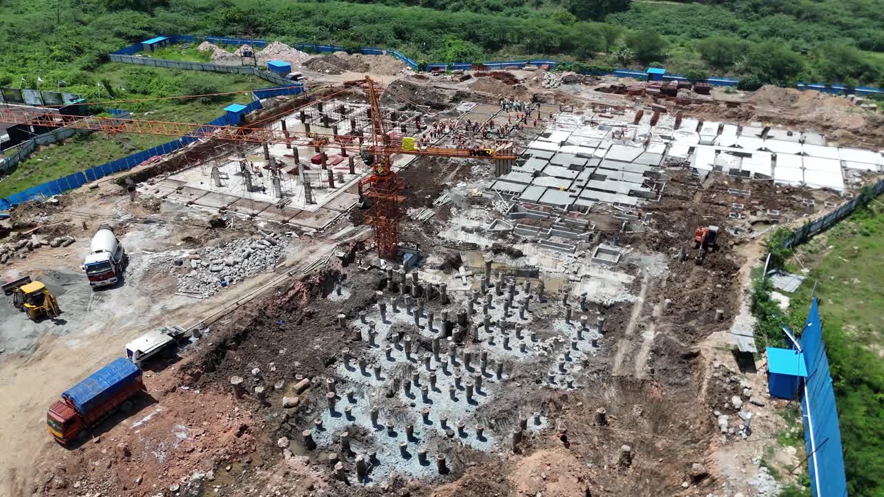 Drone shot circling around a tall under-construction tower