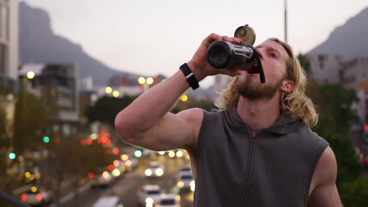 hombre caucásico deportivo bebiendo agua
