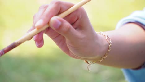 Close-up-shot-Hand-of-female-artist-holding-painting-brush-stick