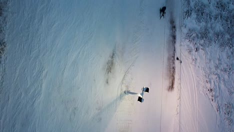 a top-down drone aerial of a ski lift in the evening