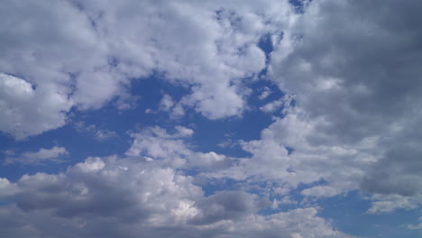 Flauschige-Weiße-Wolken-Ziehen-über-Einen-Klaren-Blauen-Himmel