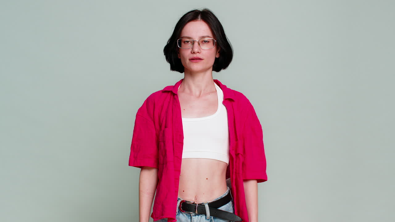 Woman covering ears with hands turning head away indicating unwillingness to hear refuse gesture