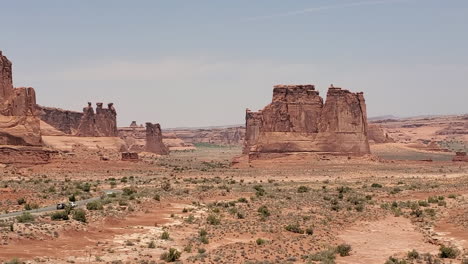 arches national park, three gossips rock formation and desert road in courthouse towers area, moab, utah usa