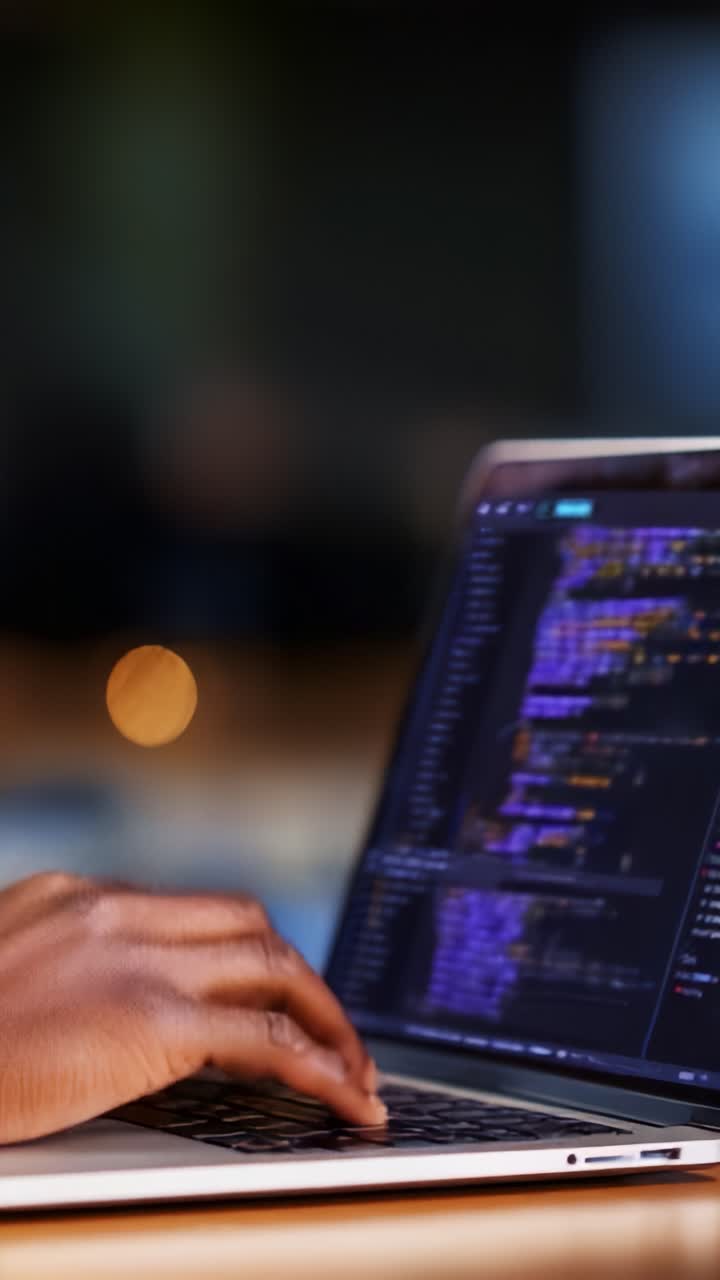 Engaged in Coding: A Close-Up of Hands Typing on a Laptop with Colorful Code Displayed, Showcasing Digital Programming and Development Skills