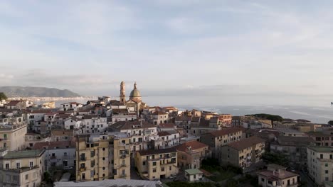 Salerno-Italy-Aerial-over-city-towards-Sea-at-Sunset