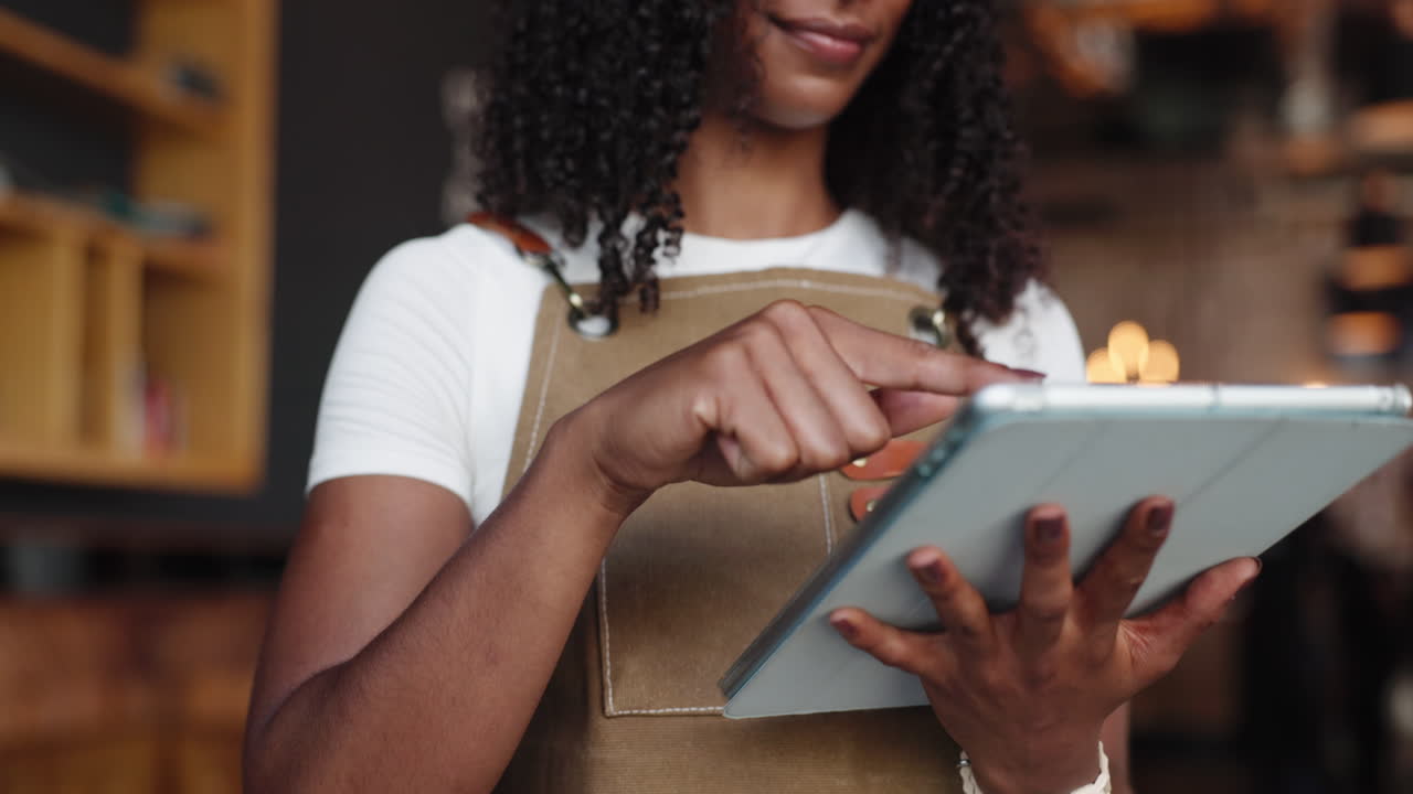 Smiling Woman in Apron Using Digital Tablet with Stylus
