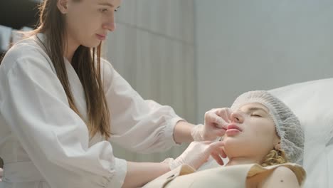 close-up of cosmetologist performing facial injection