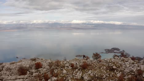 rocky shore of immense lake skadar in a cloudy day