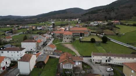 aerial pullback of sideview of santa maria de xunqueira monastery