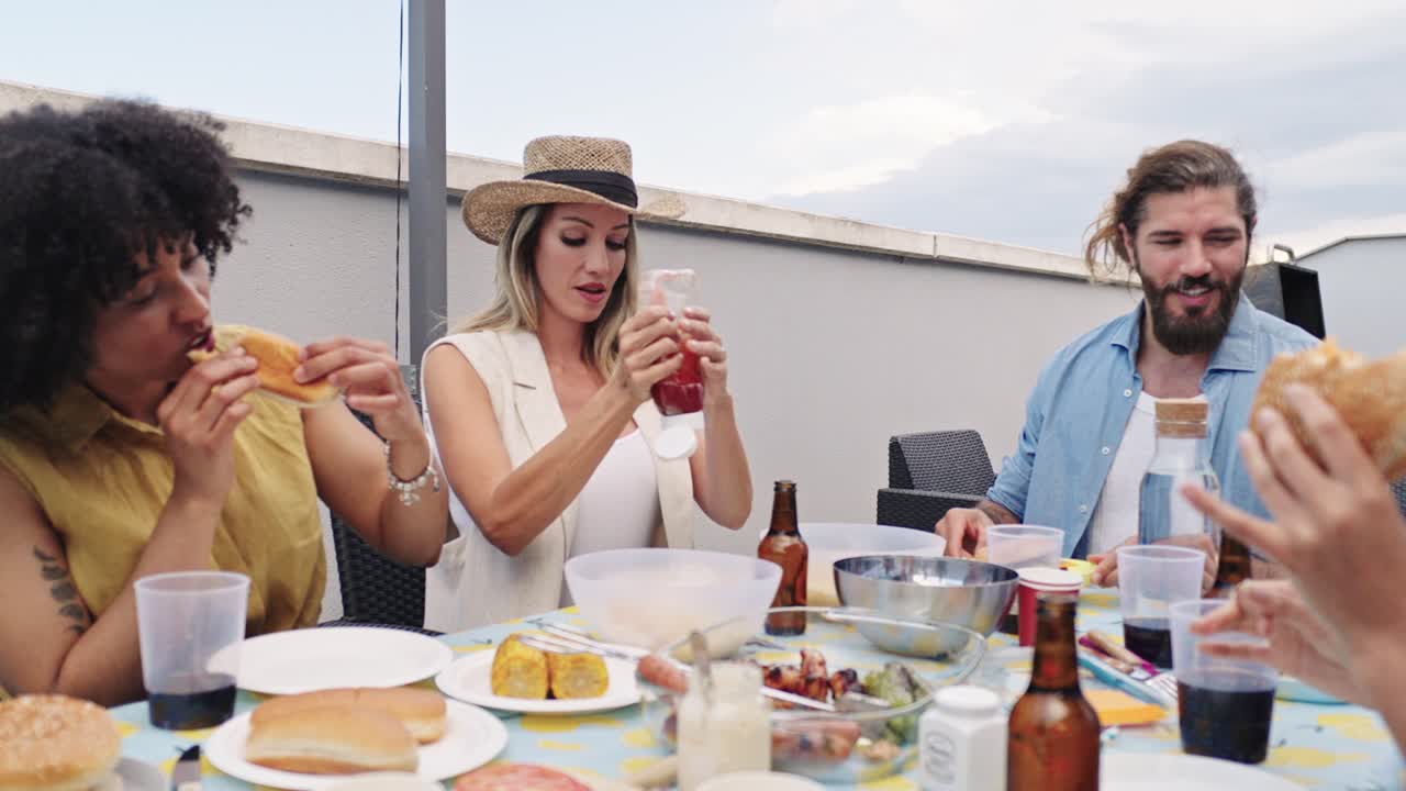 Friends eating food at a barbecue party