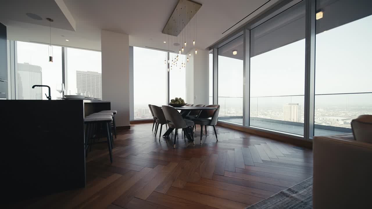 a luxury dining room table set in a large high rise condo, wide push in
