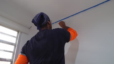 painter using brush to paint wall - close up