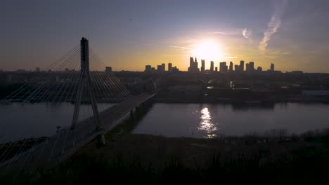 an onward aerial drone shot of a sunset from warsaw, the capital city and largest city in poland