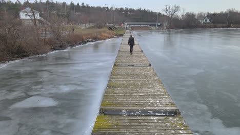 aerial drone following a young woman on a winter day