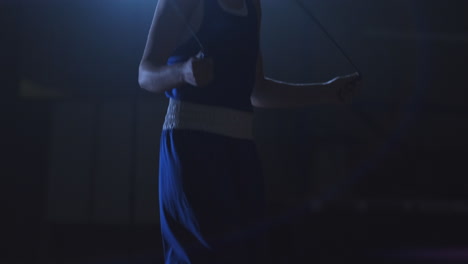 beautiful female boxer jumping rope during active boxing training