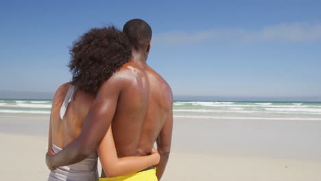 Couple-embracing-each-other-at-beach-4k