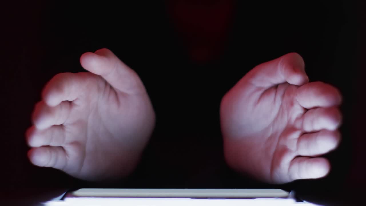 Video of caucasian man's hand and smartphone with blank screen on black background