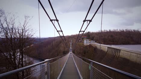 walking on longest suspension bridge in germany next to huge water dam