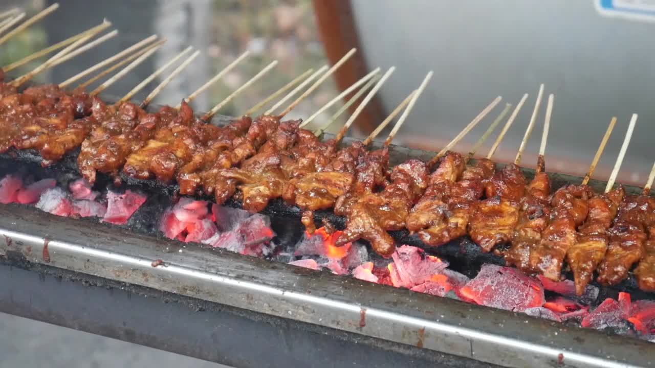 Chicken satay cooking process. grilled chicken over coals. Indonesian culinary