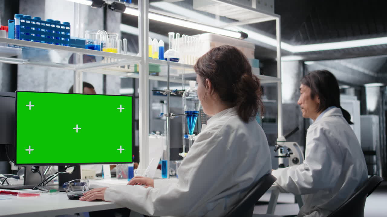 Vertical video Scientist using green screen computer in laboratory, driving treatment discovery