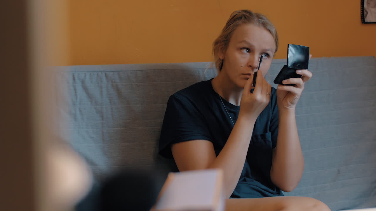 женщина наносит макияж перед выходом