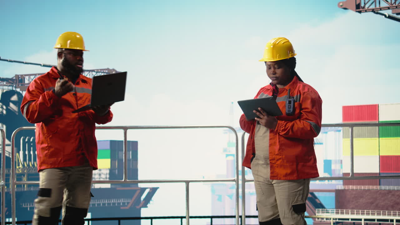 Vertical video Offshore platform colleagues supervising deck operations with devices