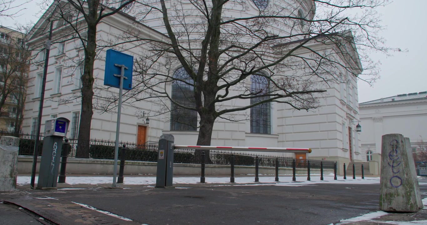 Parking gate in front of a church in Poland on a cloudy day