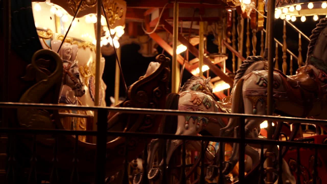 밤에는 말과 화려한 조명이 있는 원형 회전목마 또는 회전목마