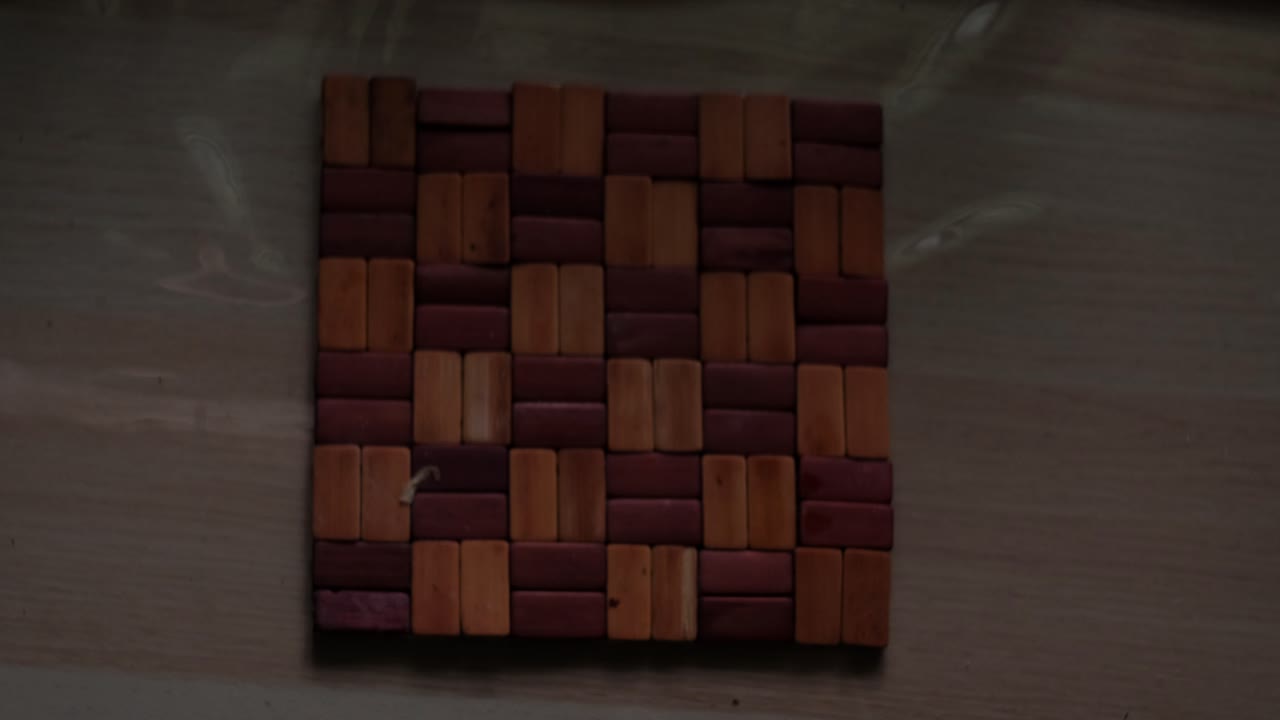 Static top-down close-up shot of hands placing glass coffee carafe and V60 dripper for pour-over setup
