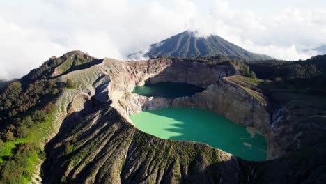 Stunning-aerial-view-of-Kelimutu-Volcano-in-Indonesia,-showcasing-its-unique-crater-lakes-and-dramatic-landscape