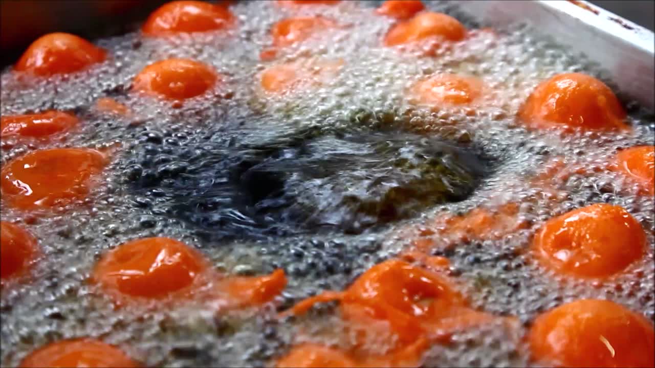Close up video shot quail eggs with flour batter being deep fried